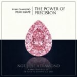 Loose fancy vivid pink pear diamond showing crisp facet lines and brilliant light dispersion on a soft white surface.