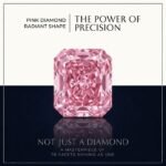 Loose fancy vivid pink [heart/radiant] cut lab grown diamond with brilliant light reflections on a soft white surface.
