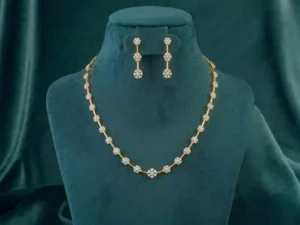 Petal cluster diamond station necklace set in 14k gold featuring round brilliant cut lab grown diamonds in a floral arrangement.