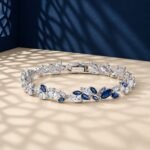 A high-end macro photo of a marquise lab diamond tennis bracelet with white and blue stones