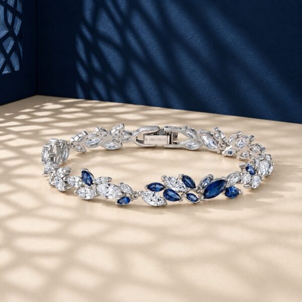 A high-end macro photo of a marquise lab diamond tennis bracelet with white and blue stones