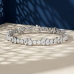 A close-up macro photo of a pear and round diamond tennis bracelet