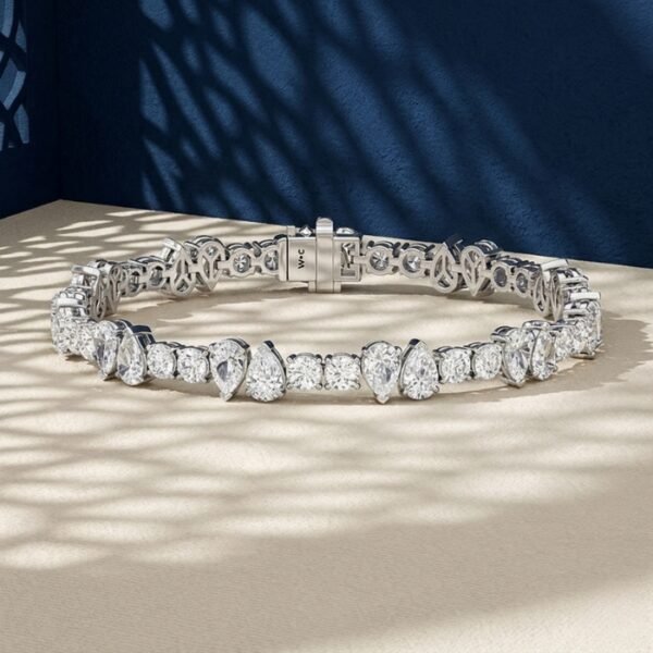A close-up macro photo of a pear and round diamond tennis bracelet