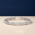 A close-up macro photo of a pear and round diamond tennis bracelet