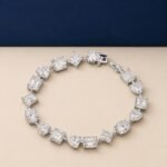 : A high-end macro photo of a mixed shape lab diamond tennis bracelet with emerald, pear, and heart-cut stones titled Tennis Bracelet