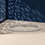 A professional macro photo of an oval cut lab diamond tennis bracelet in white gold.
