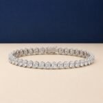 A professional macro photo of an oval cut lab diamond tennis bracelet in white gold.