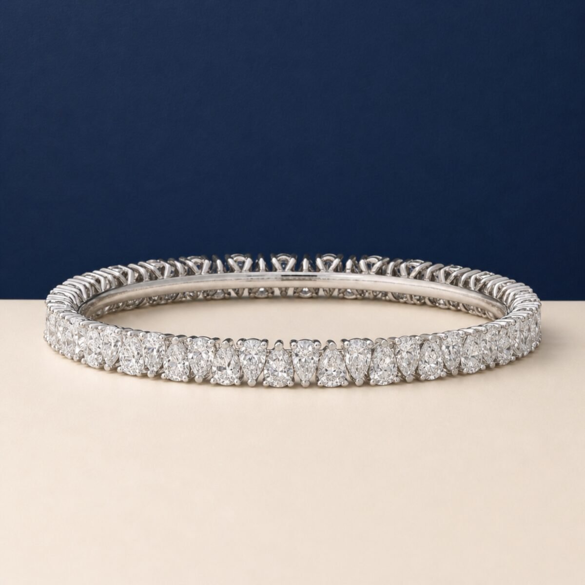 A high-end macro photo of a pear-cut lab-grown diamond tennis bracelet titled Tennis Bracelet