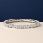 A high-end macro photo of a pear-cut lab-grown diamond tennis bracelet titled Tennis Bracelet