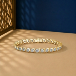 Teardrop bezel-set lab-grown diamond tennis bracelet available in gold and sterling silver 925 finishes.