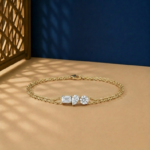 Multi Shape Lab Diamond Bracelet with emerald pear and round diamonds on a double gold chain.