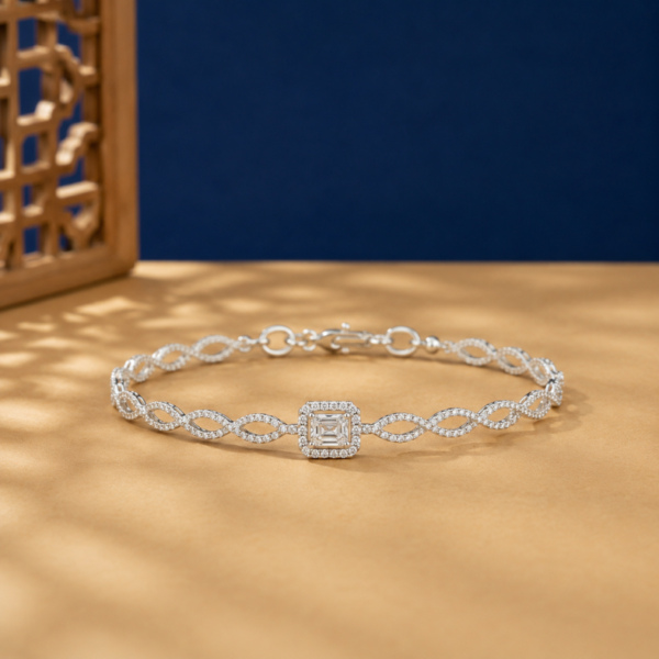 Infinity emerald cut lab diamond bracelet with pavé twist chain and halo center.