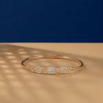 Floral lab diamond bangle bracelet in rose gold finish with circular accents.