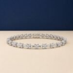 Flora design lab-grown diamond tennis bracelet shown on a split blue and cream background.
