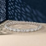 Halo lab-grown diamond mixed-cut bracelet featuring emerald and pear stones in a white-toned metal.