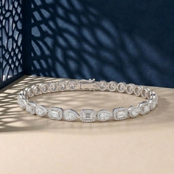 Halo lab-grown diamond mixed-cut bracelet featuring emerald and pear stones in a white-toned metal.