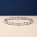 Halo lab-grown diamond mixed-cut bracelet featuring emerald and pear stones in a white-toned metal.