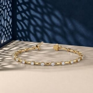 Luminous marquis link lab-grown diamond bracelet shown in a yellow-toned metal on a textured neutral surface.