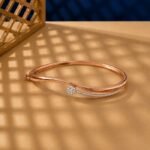 Rose gold bypass bangle with a lab diamond cluster and pavé-set diamond trail.