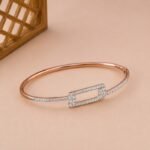 Rose gold geometric bangle with a rectangular lab diamond frame and pavé shoulders