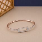 Rose gold geometric bangle with a rectangular lab diamond frame and pavé shoulders.
