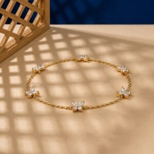 Marquise lab diamond butterfly charm bracelet in yellow metal.