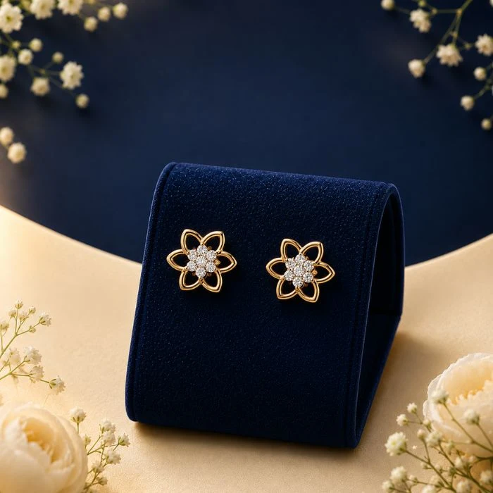 Fleur Luxe Flower Cluster Lab-Diamond Studs Pair of 18K yellow gold six-petal flower openwork stud earrings featuring a center cluster of sparkling lab-grown diamonds, displayed on a blue velvet stand.
