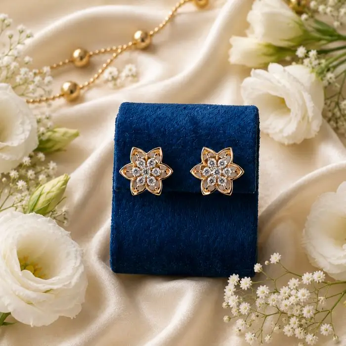 Yellow Gold Lab Diamond Flower Cluster Studs Pair of 14K yellow gold lab-grown diamond flower cluster stud earrings resting on a blue velvet stand.