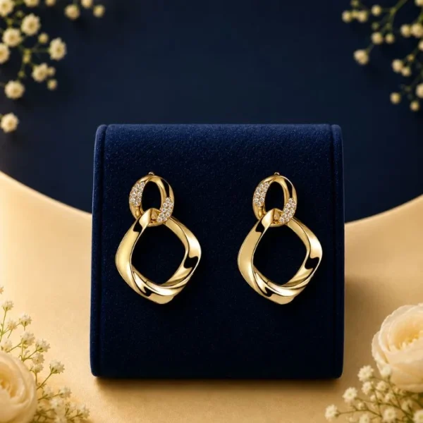 Celestial Link lab grown diamond earrings in gold with modern open drop design on navy luxury display