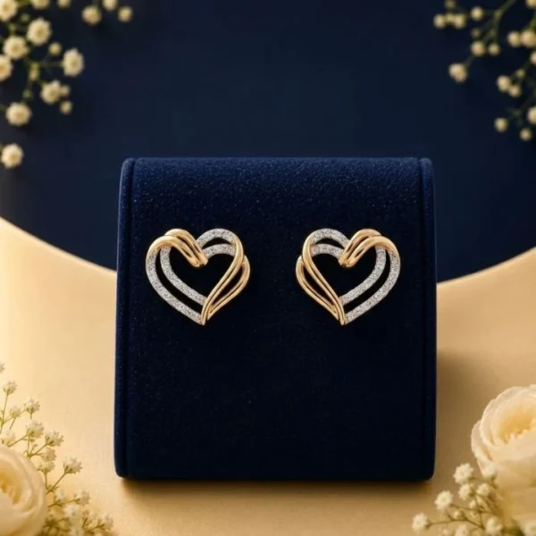 Lab grown diamond heart earrings in gold and white diamond design on navy velvet jewellery display
