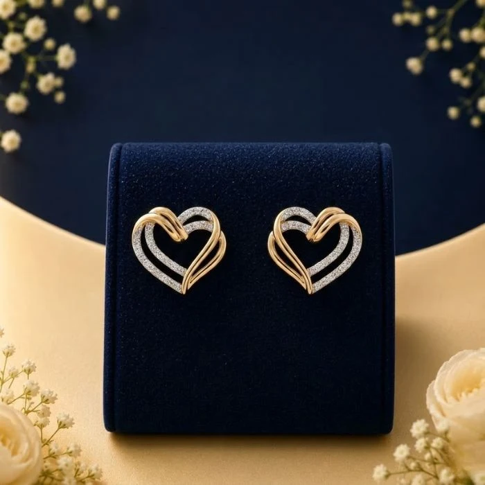 Amora Heart Lab Grown Diamond Earrings Lab grown diamond heart earrings in gold and white diamond design on navy velvet jewellery display