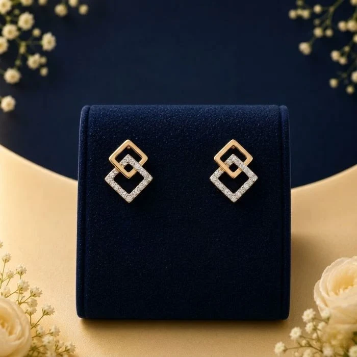 Aurelia Square Lab Grown Diamond Earrings Lab grown diamond square earrings in gold with interlocked geometric design on navy velvet jewellery display