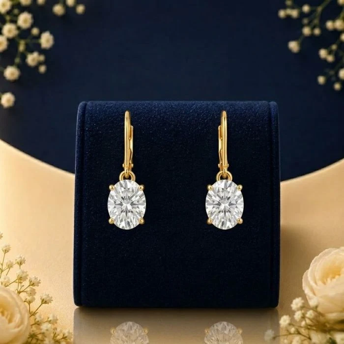 Solitaire Grace Lab Grown Diamond Drop Earrings Lab grown diamond drop earrings with round solitaire diamonds on navy velvet jewellery display