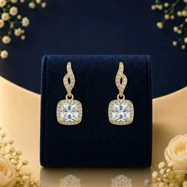 Lab grown diamond cushion drop earrings with halo design on navy velvet jewellery display