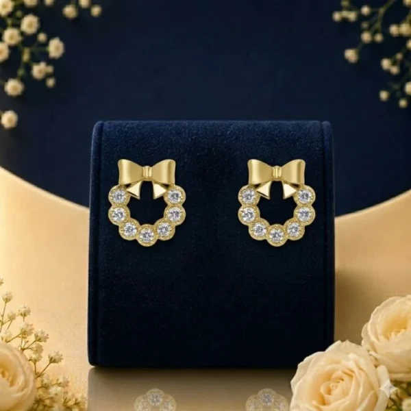 Lab grown diamond bow earrings with sparkling round diamonds on navy velvet jewellery display