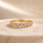 Heart-shaped bezel-set lab diamond eternity ring in yellow gold with sparkling heart diamonds