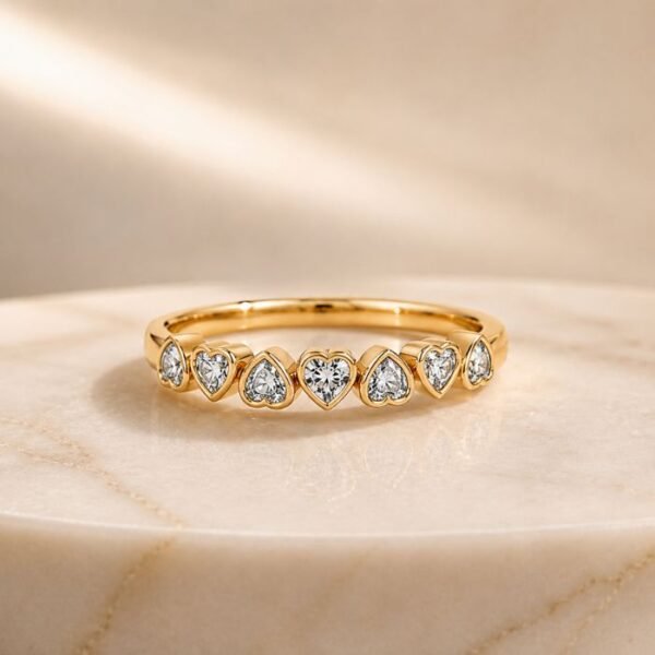 Heart-shaped bezel-set lab diamond eternity ring in yellow gold with sparkling heart diamonds
