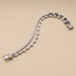Two Row Lab Diamond Tennis Bracelet featuring two rows of round diamonds in a rose gold setting on a warm background.
