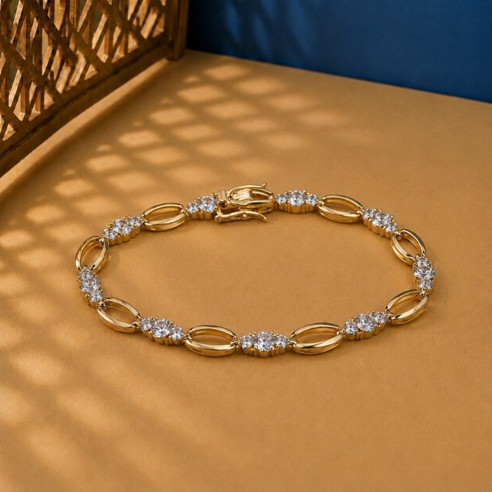 Oval Link Lab Diamond Bracelet - Modern Geometric Gold Design. Oval Link Lab Diamond Bracelet featuring alternating polished gold ovals and diamond clusters on a tan background.