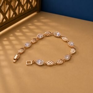 Pear Cut Lab Diamond Lattice Bracelet featuring alternating pear-cut diamond halos and rose gold lattice links on a tan background.