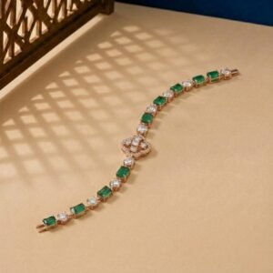 Emerald and Lab Diamond Bracelet featuring alternating green emeralds and round diamonds with a center clover motif.