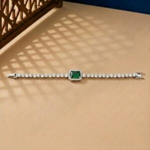 Emerald Halo Lab Diamond Bracelet featuring a green emerald-cut center stone with a diamond halo on a tan background