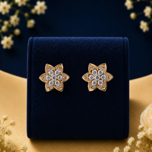 Pair of 14K yellow gold lab-grown diamond flower cluster stud earrings resting on a blue velvet stand.