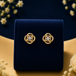 Gold floral stud earrings with lab grown diamonds on a blue velvet box