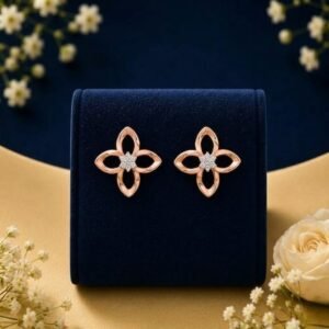 14k gold flower diamond studs featuring a 4-petal open motif with a central diamond cluster, displayed on a blue velvet stand.