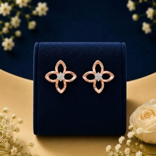 14k gold flower diamond studs featuring a 4-petal open motif with a central diamond cluster, displayed on a blue velvet stand.