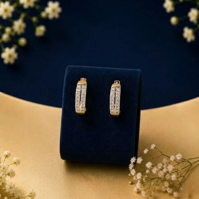 gold-double-row-hoops-diamond-earrings A pair of 14k gold double row hoops featuring two parallel lines of lab-grown diamonds, displayed on a blue velvet jewelry stand.