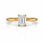 Rectangular emerald cut diamond yellow gold ring in a four prong setting
