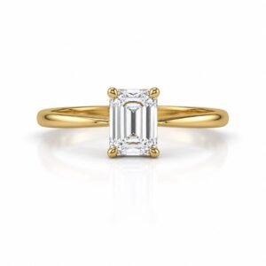 Rectangular emerald cut diamond yellow gold ring in a four prong setting