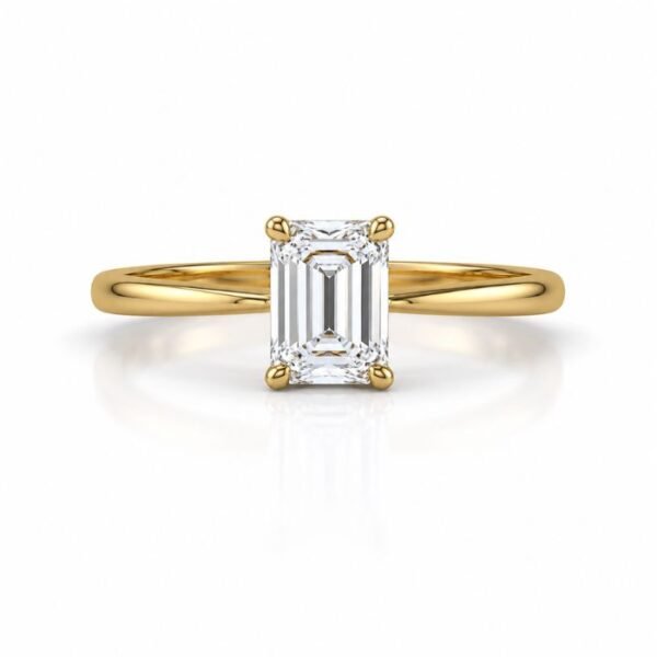 Rectangular emerald cut diamond yellow gold ring in a four prong setting